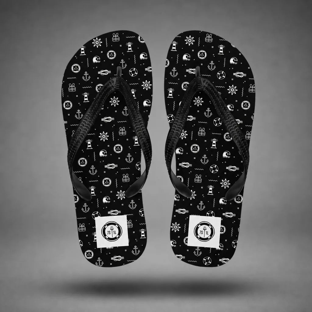 Alternate view of black Beach Activity flip-flops with nautical icon pattern, floating above a grey studio floor with a soft shadow.