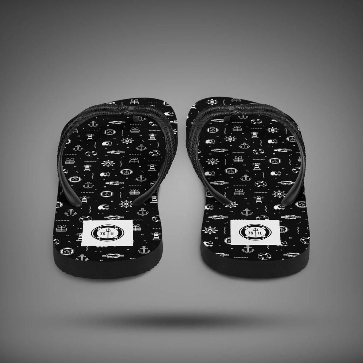 Beach Activity flip flops seen from the heel, black soles with white nautical icons and black straps