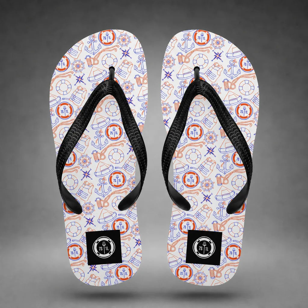 Alternate view of red, white, and blue Coast Guard flip-flops with Coast Guard maritime pattern, floating above a grey studio floor with a soft shadow.