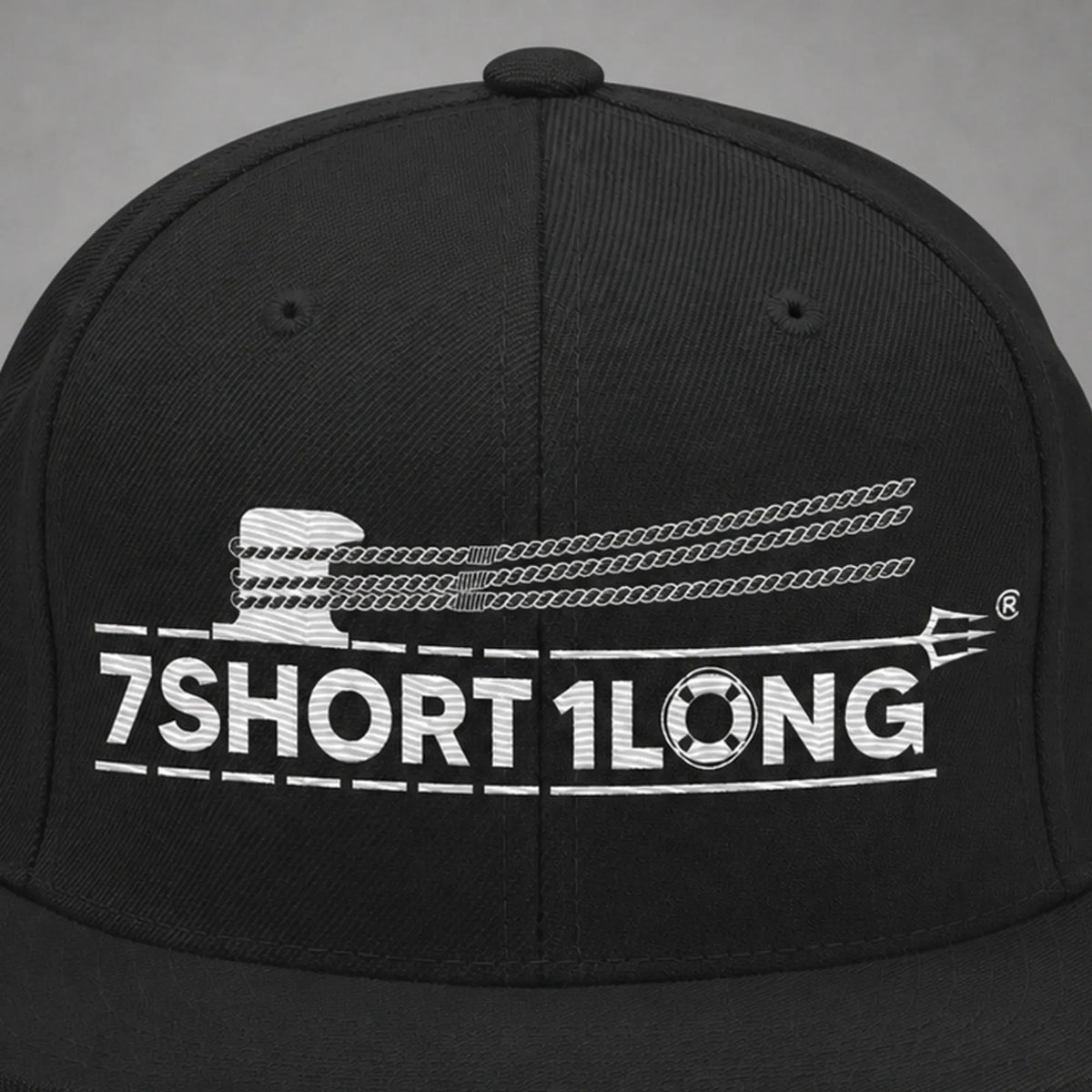 Close view of the Deck Hand rope and signal embroidery on a black snapback cap.