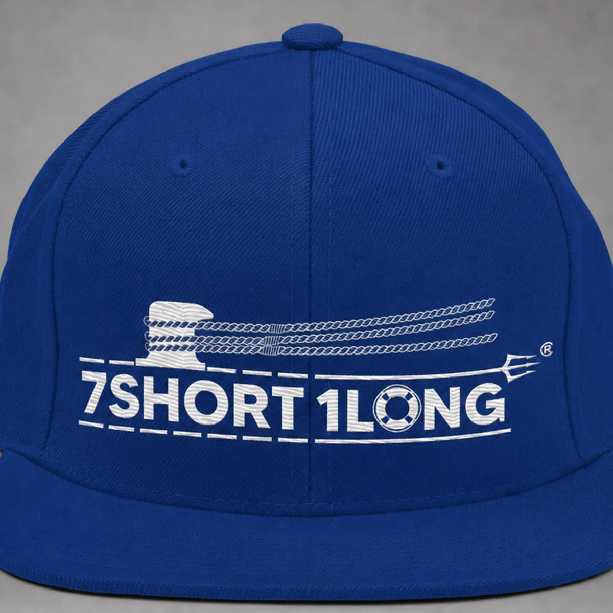 Close view of the Deck Hand rope and signal embroidery on a royal blue snapback cap.