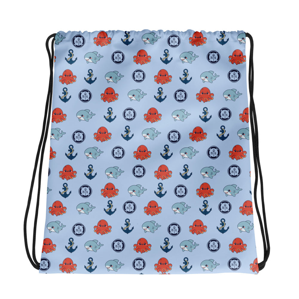 bag with nautical pattern featuring octopuses, anchors, and baby sharks on a light blue background.