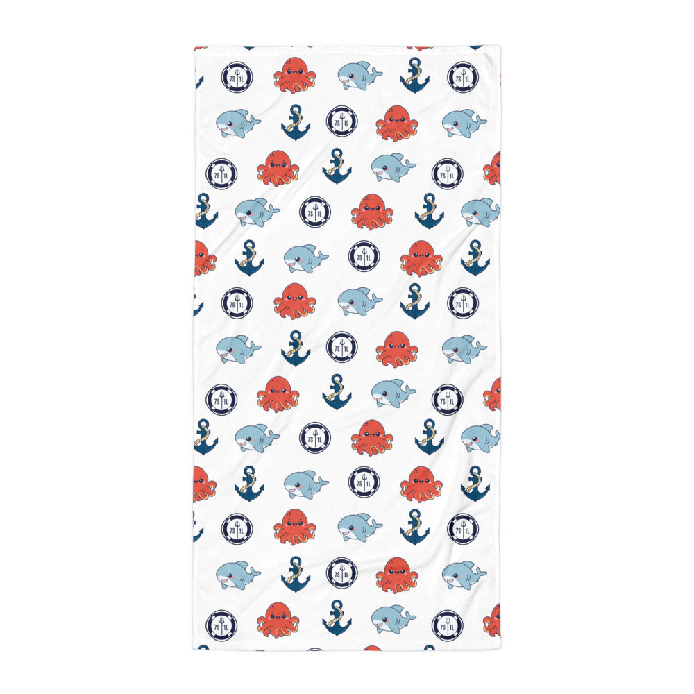 Towel with nautical pattern featuring octopuses, sharkd, and anchors on a white background