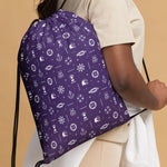 Person wearing a purple day bag with  cruise ship patterns on a beige background