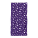 Purple towel with white maritime-themed icons on a white background