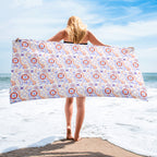 Woman holding a us coast guard patterned towel on a beach
