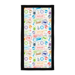 Towel with colorful travel-themed stamps pattern on a white background