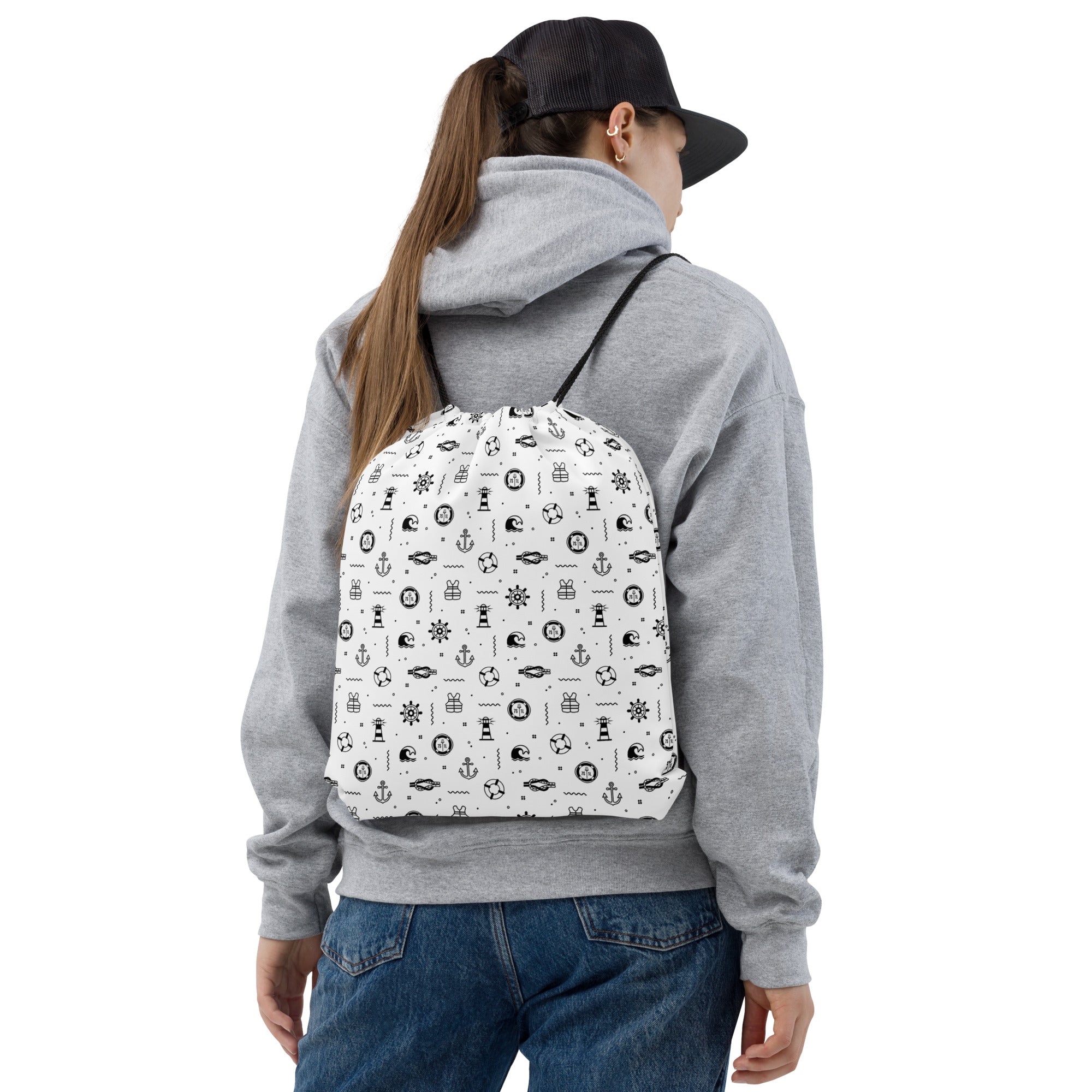 Person wearing a gray  backpack featuring black cruise ship patterns on a white background