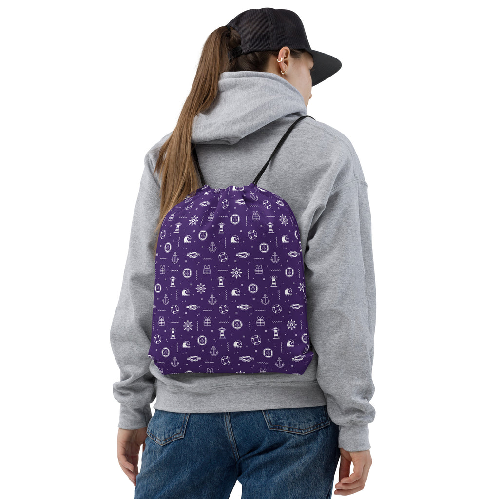 Person wearing apurple backpack with white nautical patterns on a cruise ship