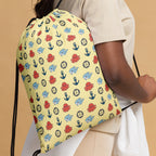 Drawstring bag with colorful octopus pattern held by a person against a beige background