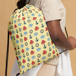 Drawstring bag with colorful octopus pattern held by a person against a beige background