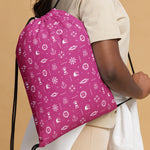 Person wearing a pink drawstring bag with white patterns on a beige background