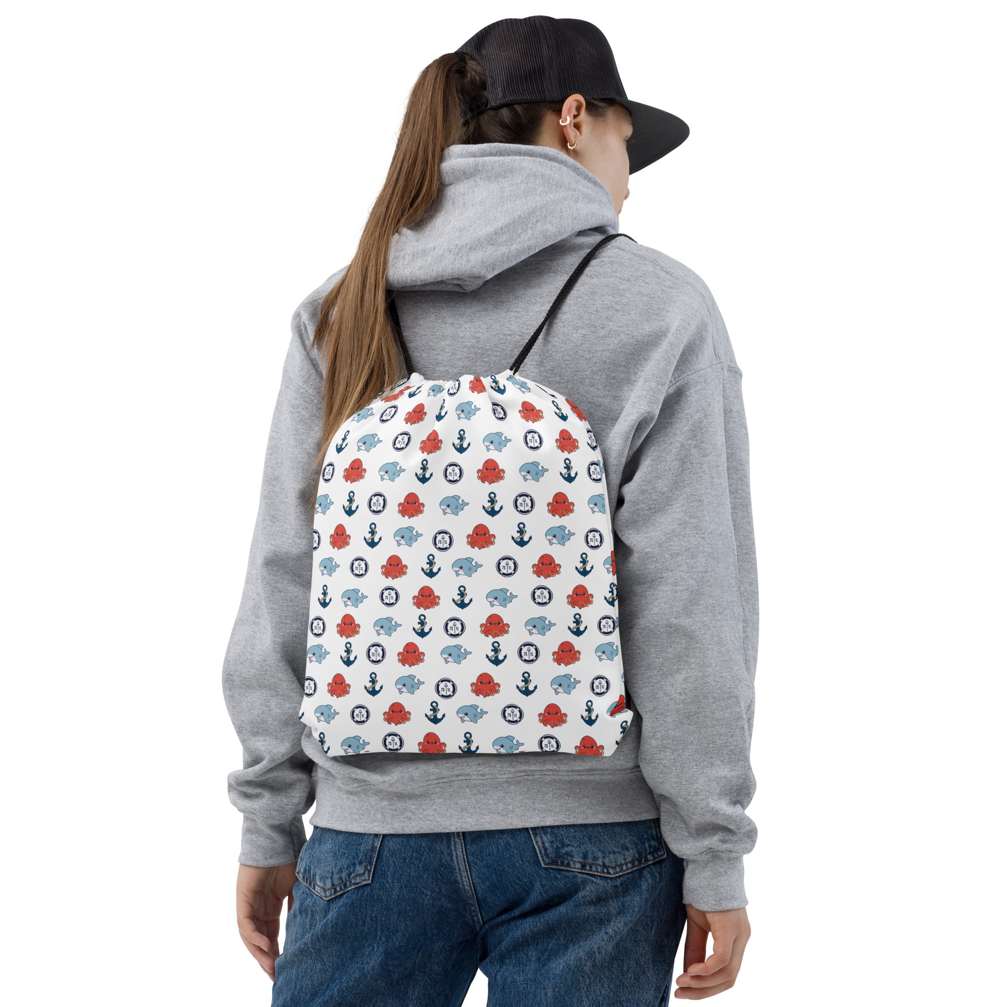 Person wearing a gray hoodie with a colorful backpack featuring Ocean Animals PE Bag pattern