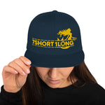Snapback cap navy with 7-Shot-One-Long logo in gold and mermaid design, inspired by maritime folklore and seafaring culture.