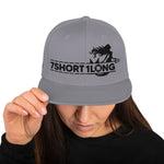 Grey Snapback cap with 7-Shot-One-Long logo and mermaid design, inspired by maritime folklore and seafaring culture.