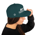 Green Snapback cap with 7-Shot-One-Long logo and mooring lines design, inspired by ship mooring operations and bringing lines ashore, adjustable snapback closure.
