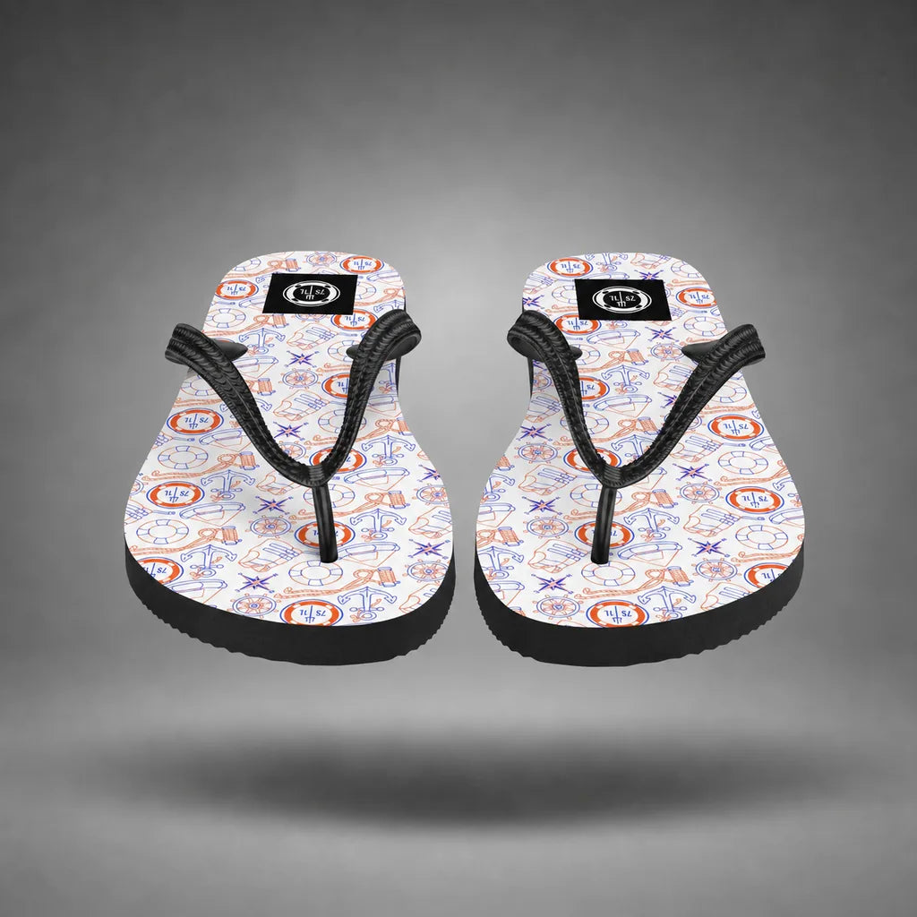 Detail view of red, white, and blue Coast Guard flip-flops with Coast Guard maritime pattern, floating above a grey studio floor with a soft shadow.