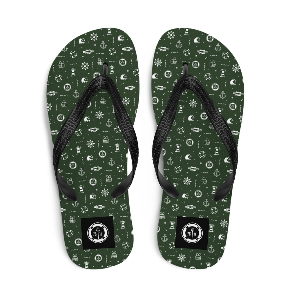 Green flip-flops with nautical pattern and black straps on a white background