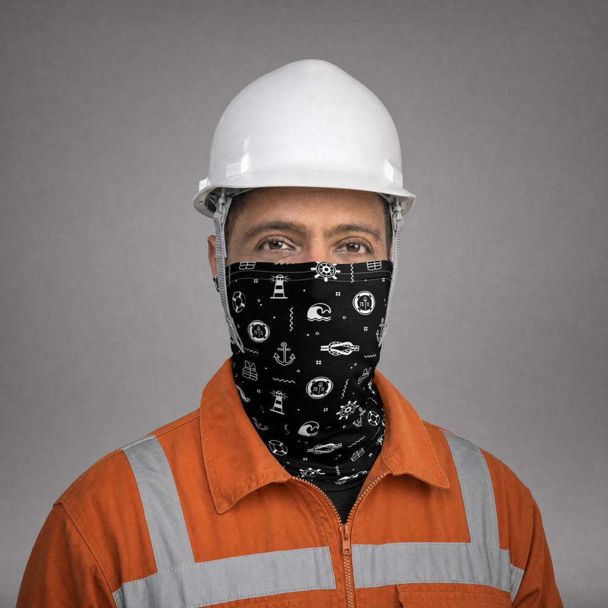 Deck rating in an orange coverall and white hard hat wearing the Deck Hand neck gaiter over nose and mouth