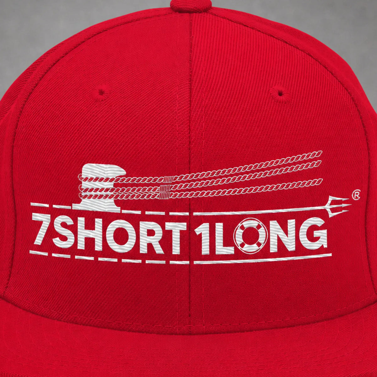 Close view of the Deck Hand rope and signal embroidery on a red snapback cap.