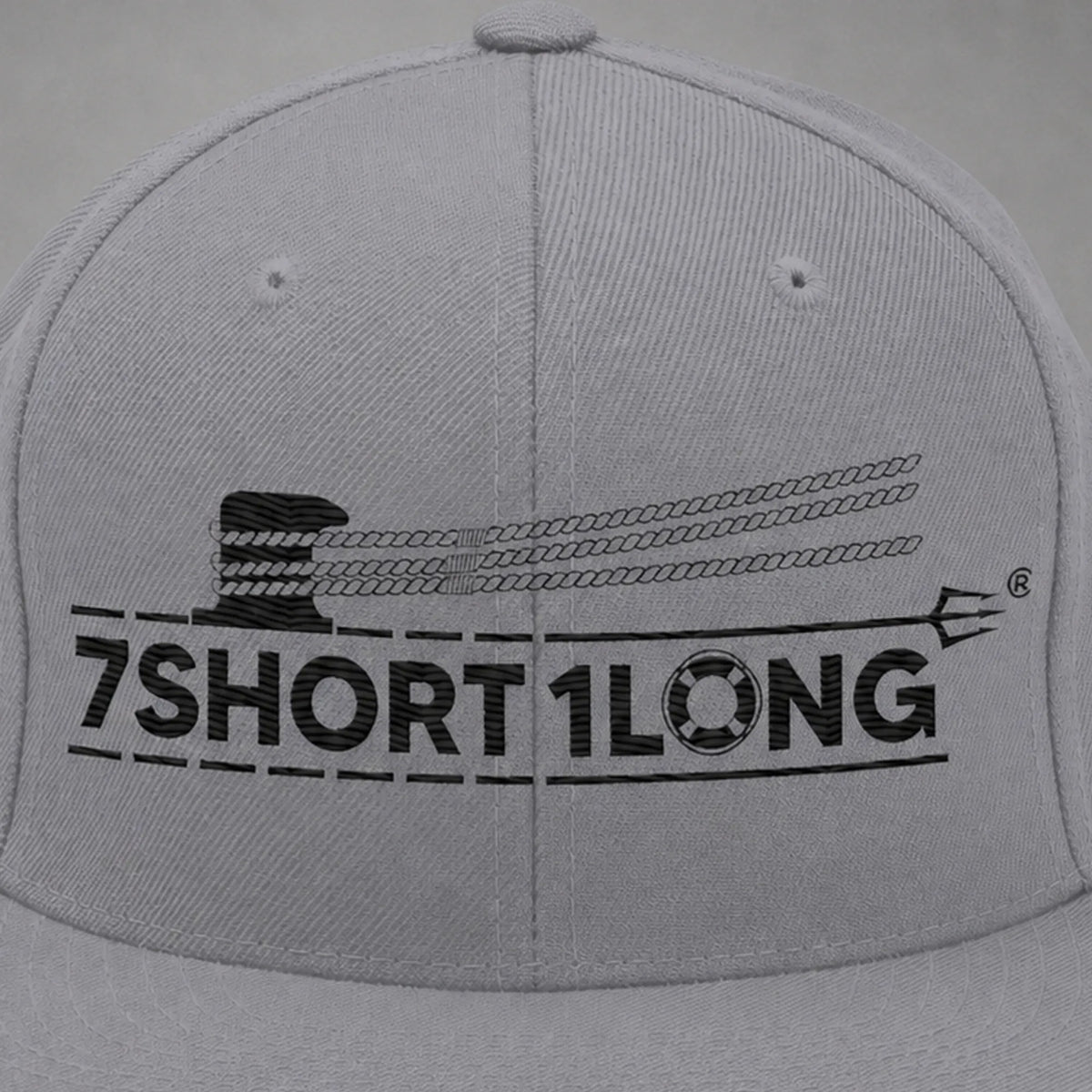 Close view of the Deck Hand rope and signal embroidery on a silver snapback cap.