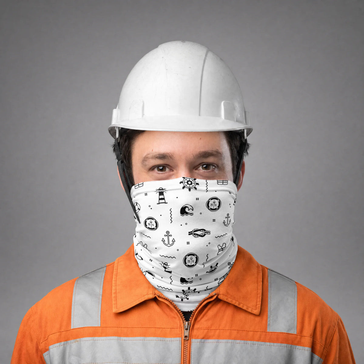 Seafarer in an orange coverall and white hard hat wearing the white Deck Work neck gaiter over nose and mouth