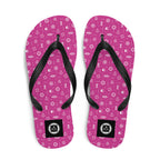 Pink flip-flops with a black strap and 7 short 1 long logo on a white background