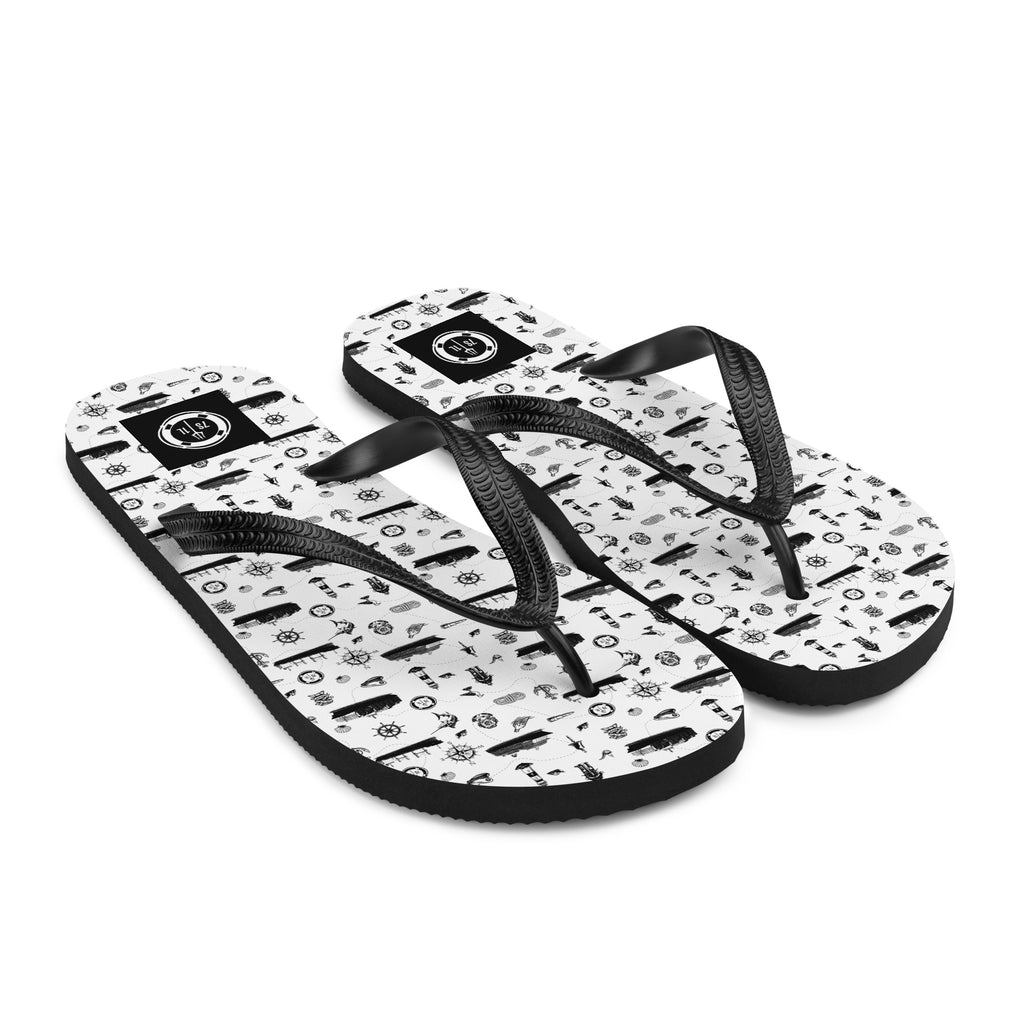 White and black Cruise Ship Lifestyle flip flops by 7SHORT1LONG® with maritime pattern, perfect for relaxed seaside wear.