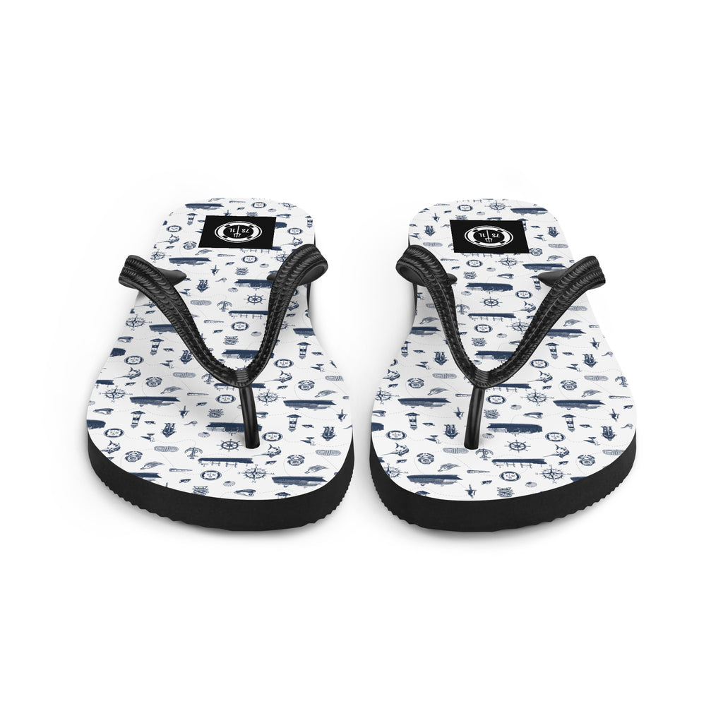 White and navy Coastal Cruise flip flops by 7SHORT1LONG® with nautical pattern, perfect for beach or casual wear.