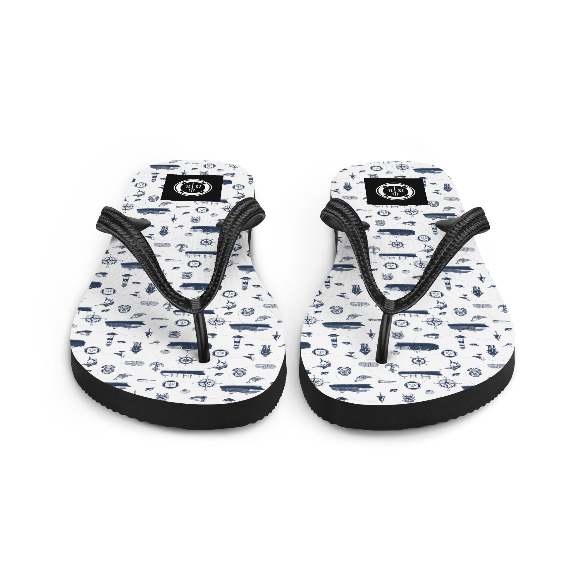White and navy Coastal Cruise flip flops by 7SHORT1LONG® with nautical pattern, perfect for beach or casual wear.