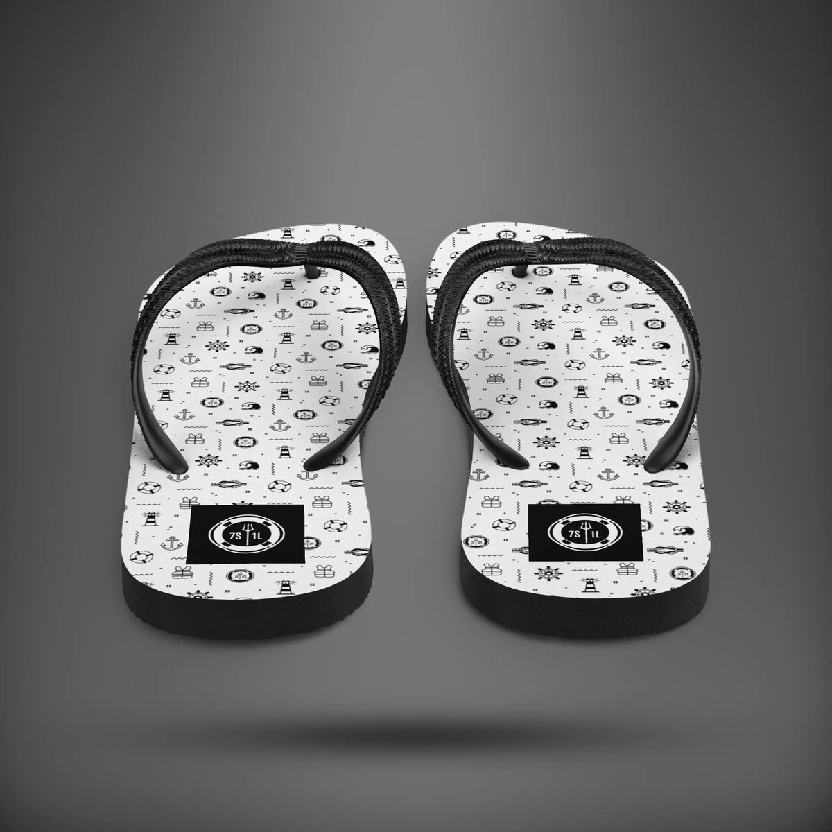Marine Life flip flops seen from the heel, white soles with black nautical icons and black straps