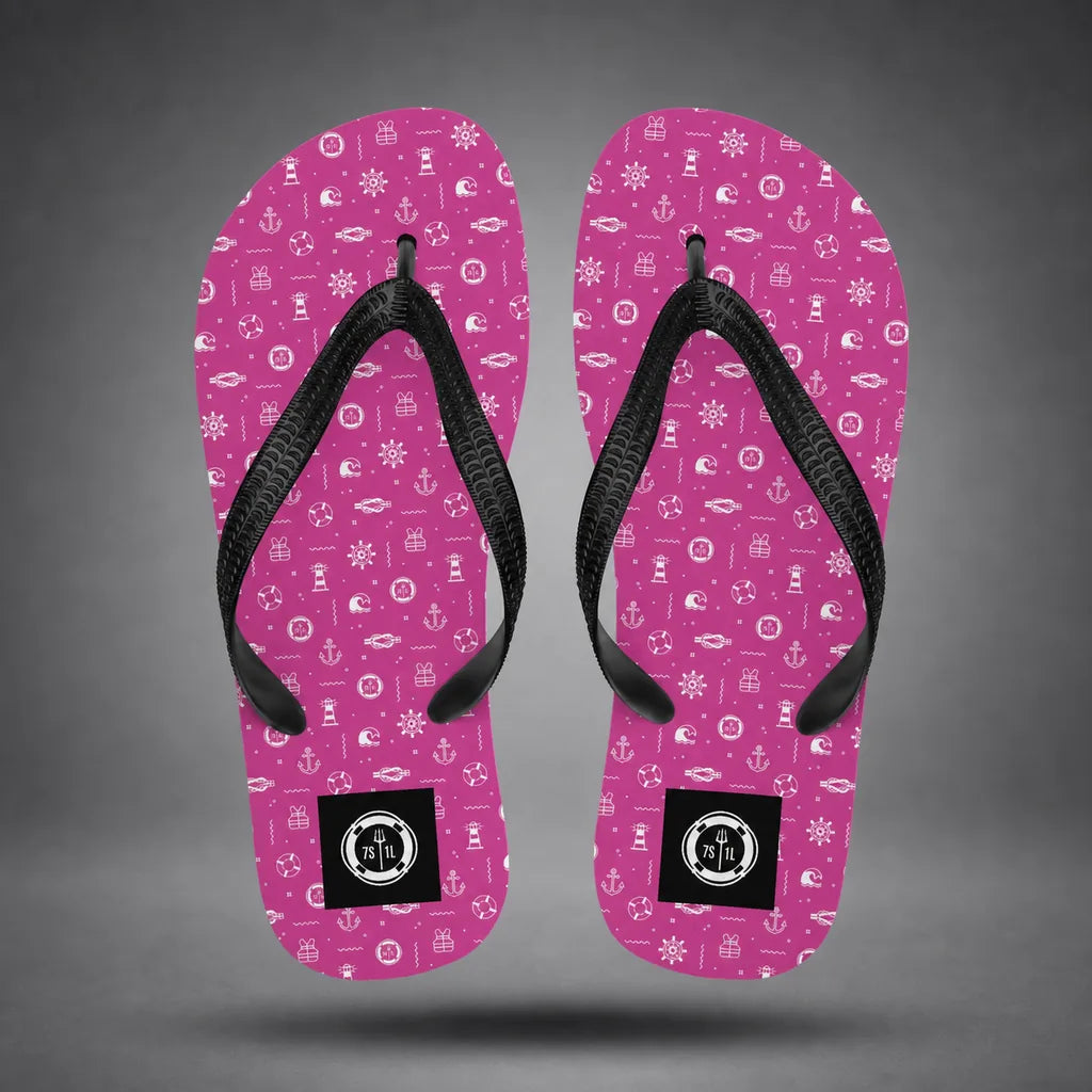 Alternate view of pink Ocean Explorer flip-flops with white maritime pattern, floating above a grey studio floor with a soft shadow.