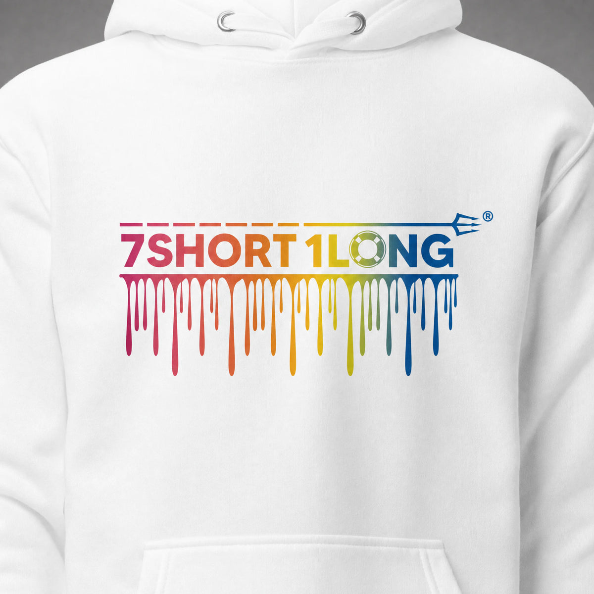 Close view of the rainbow drip wordmark on the white One Ocean hoodie, with the lifebuoy O and the trident in sharp detail.