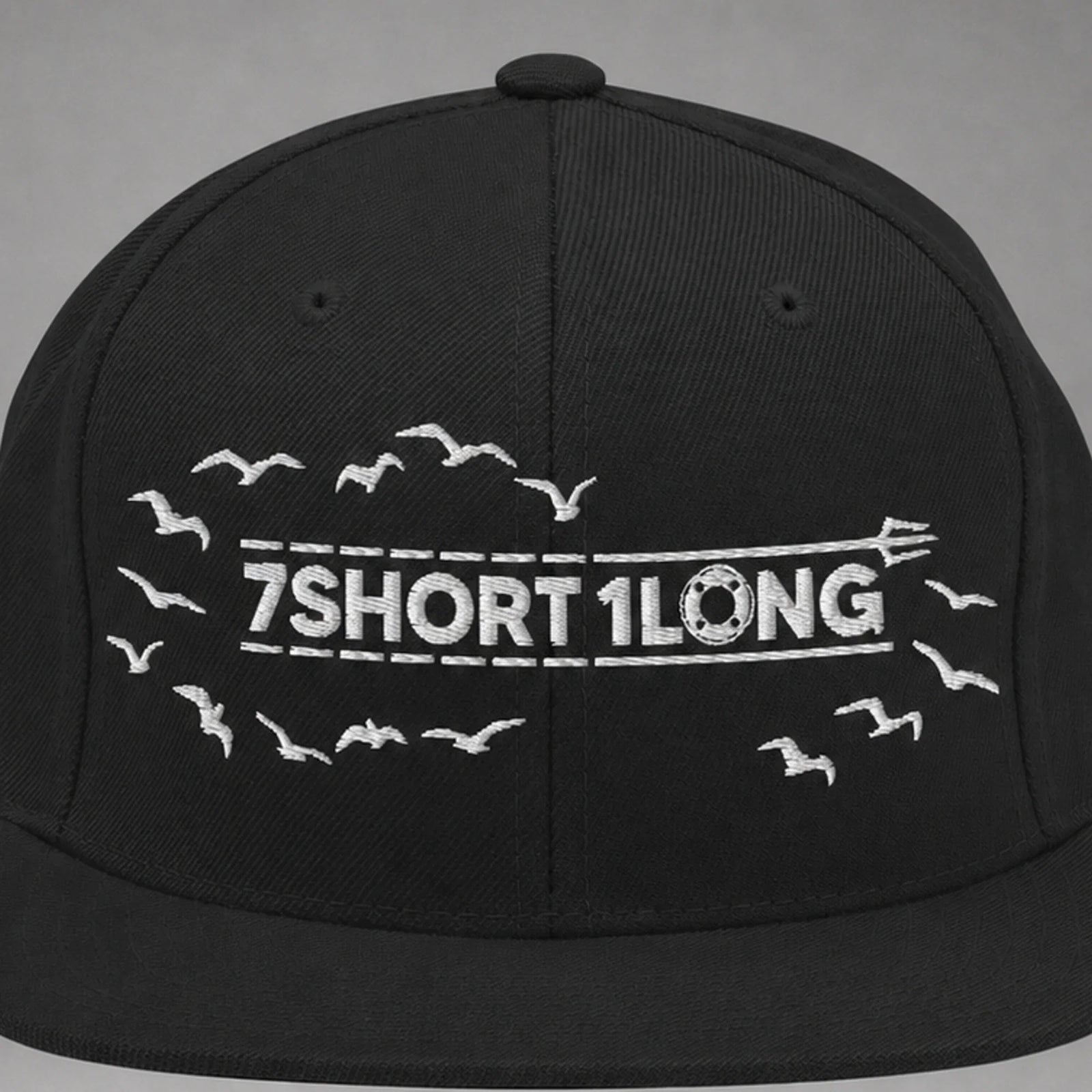 Close view of the Seagulls embroidery on a black snapback cap.