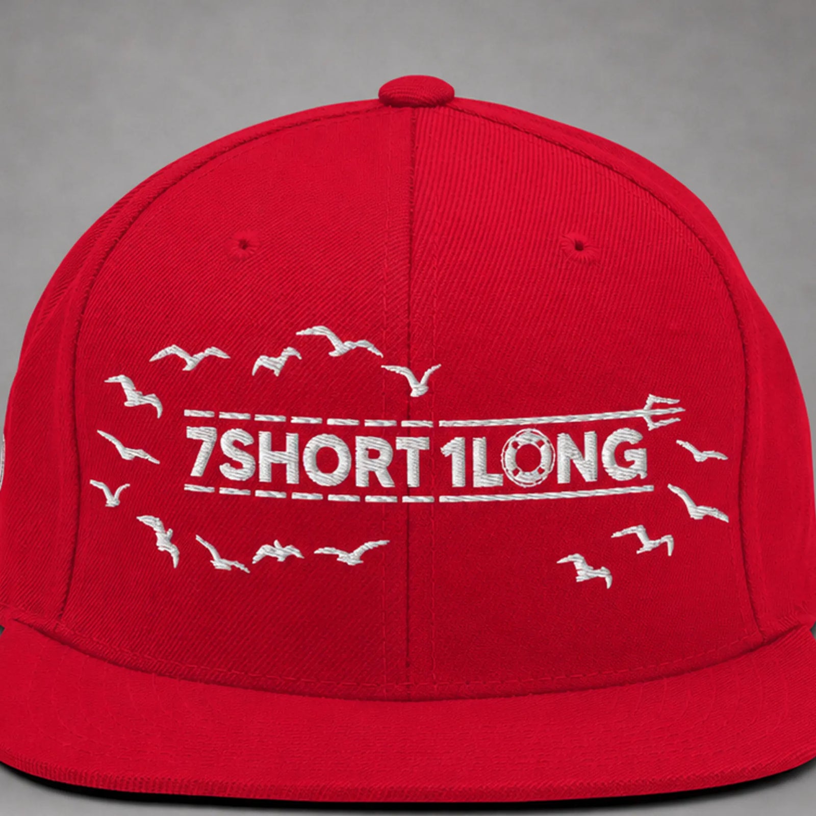 Close view of the Seagulls embroidery on a red snapback cap.