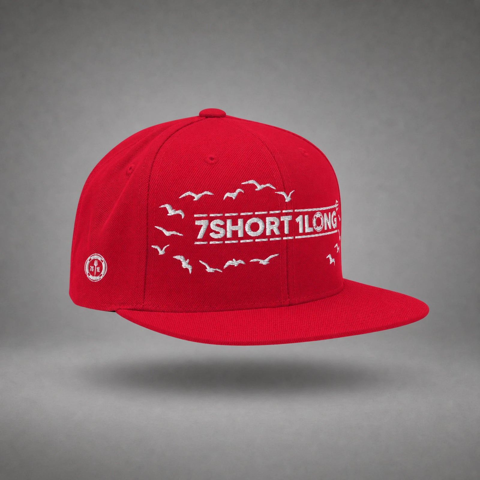 Red Seagulls snapback cap shown from the left side in a gray floating studio.