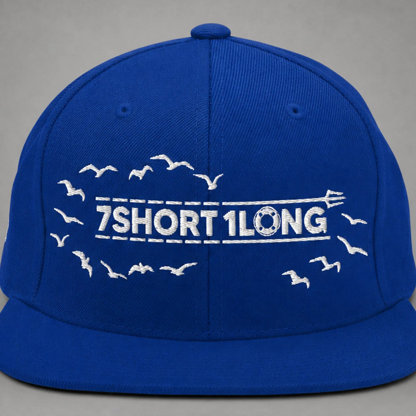 Close view of the Seagulls embroidery on a royal blue snapback cap.