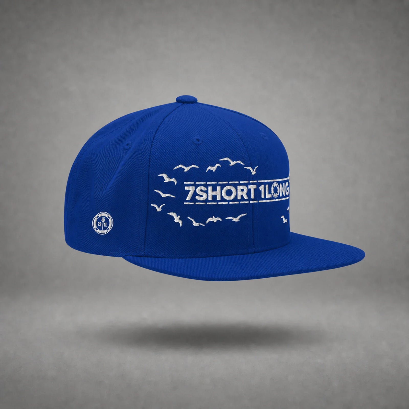 Royal Blue Seagulls snapback cap shown from the left side in a gray floating studio.