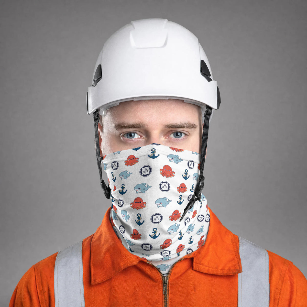 Seafarer in an orange coverall and white hard hat wearing the white Shark and Octopus neck gaiter over nose and mouth