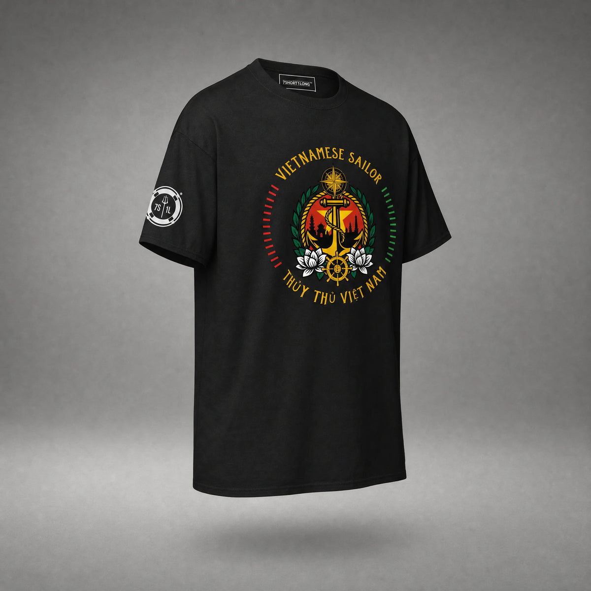 Three-quarter view of the black Vietnamese Sailor T-shirt: anchor on a red field with a yellow star, white lotus flowers and the sleeve badge.